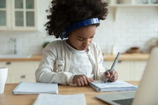 Elementary level child working on Junior Achievement material